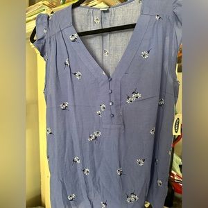 Blue shirt from Old Navy with flowers spread out throughout the shirt.